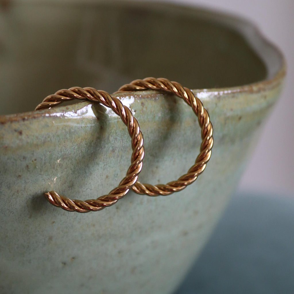 Two gold hoop earrings 